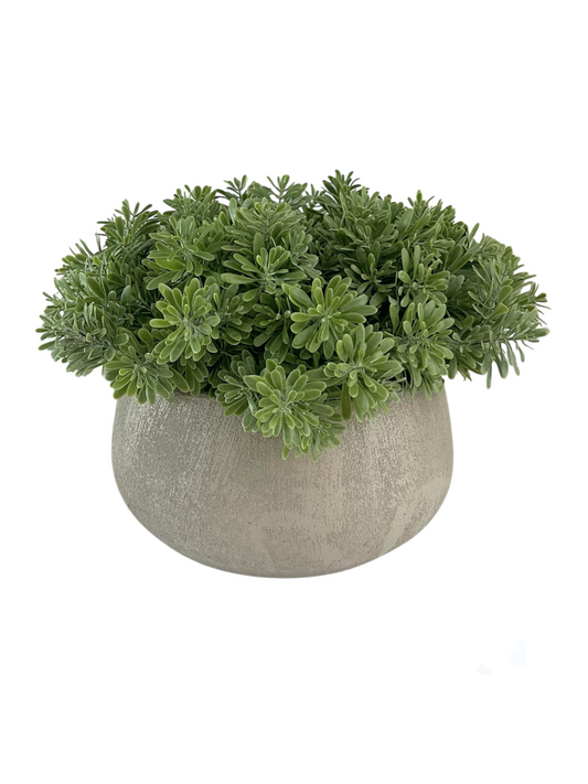 Artificial crossostephium light green succulents set in a beige terracotta bowl planter.