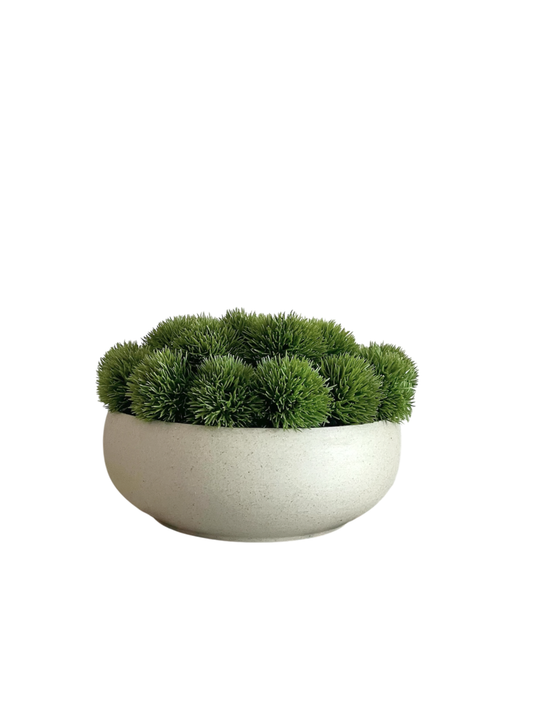 artificial green dianthus arranged in a neutral coloured bowl.