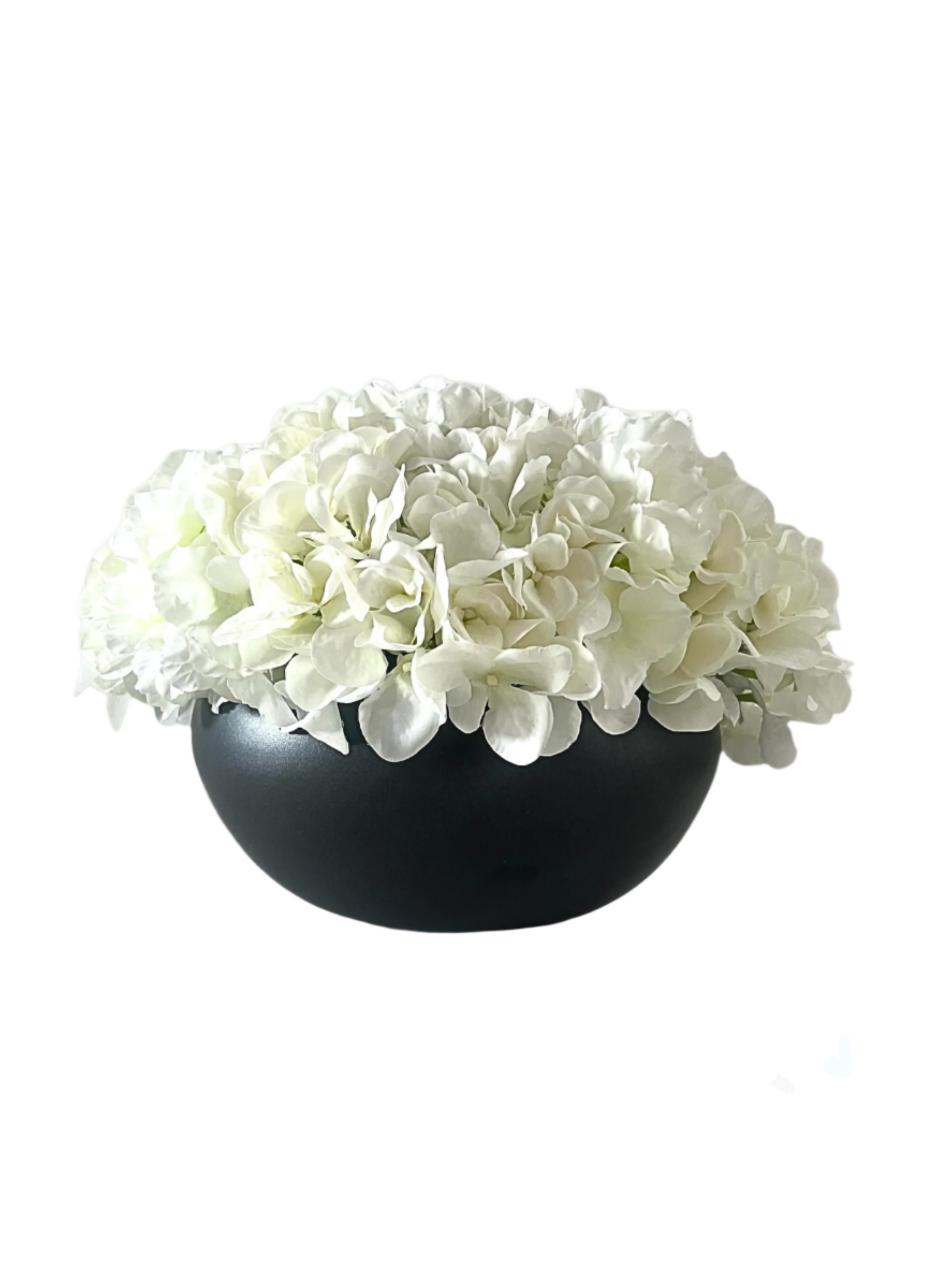 white artificial hydrangea arranged in a black ceramic bowl planter.