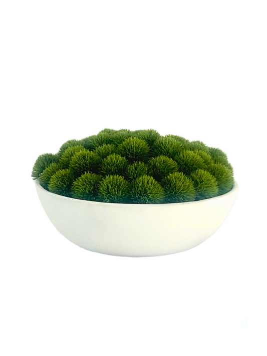 Artificial lush green dianthus set in a large concrete bowl planter.