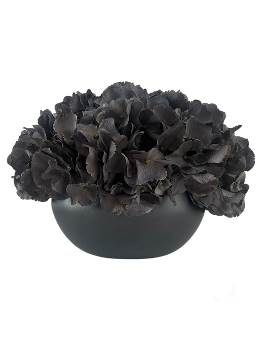 Dark grey artificial hydrangea set in a matt black ceramic bowl planter. 
